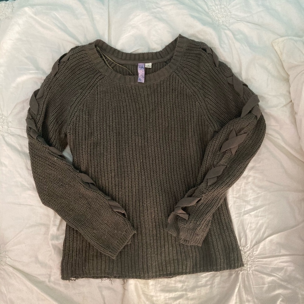green sweater with detailed sleeves